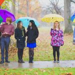 Antioch College students hold umbrellas in the rain