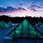 The pyramids on top of the library building glow under the sunset