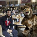 An Ursinus student and the college mascot in our Wismer Dining Facility