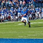 A Hillsdale College football player runs with the ball
