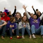 Knox football fans at end zone below the scoreboard
