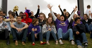 Knox football fans at end zone below the scoreboard