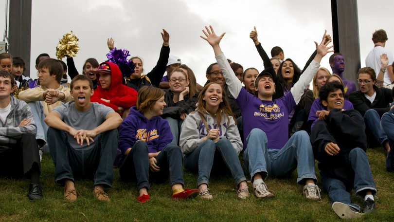 Knox football fans at end zone below the scoreboard