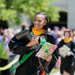 A Southwestern University student smiles in her graduation cap and gown