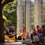 A Southwestern University professor and students enjoy class outside in the sunshine