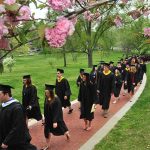 Emory & Henry College students wear graduation caps and gowns