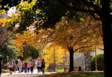 Goucher College students walk across campus on a fall day