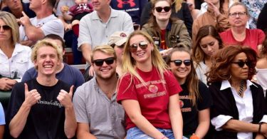 Students cheering on the Ursinus football team at a home game