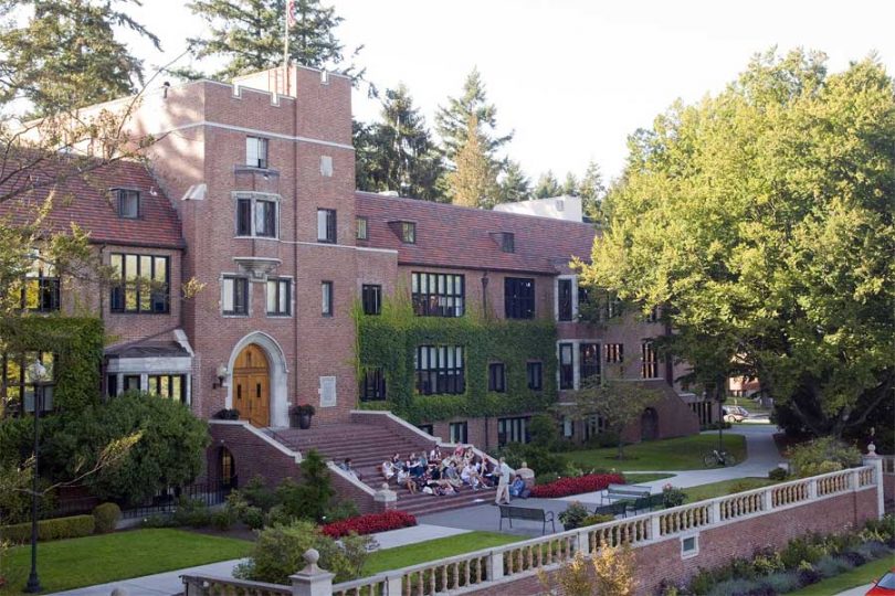 University of Puget Sound student gather in front of a campus building together