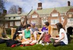 Reed College students sit on the campus lawn together