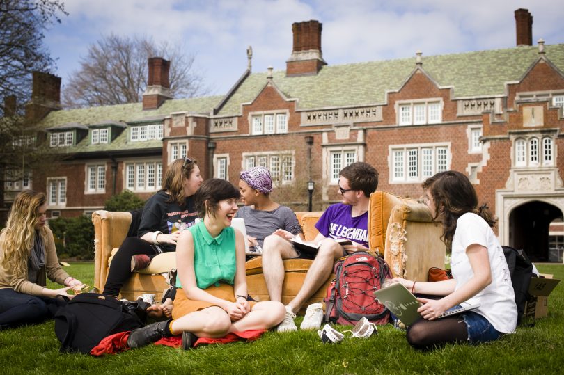Reed College students sit on the campus lawn together