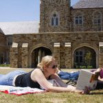 Rhodes College students read books on the campus lawn