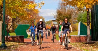 Allegheny College students ride bikes across campus