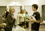 College counselor speaks with a student at a college fair