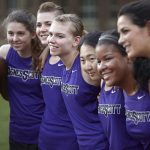 Agnes Scott athletes gather on the playing field.