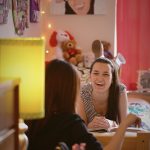 Students laughing in an Agnes Scott dorm room.