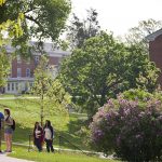 Cornell College students walk across campus on a spring day