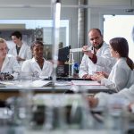 Earlham College professor talks with students in a science lab