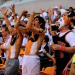 Hendrix College students cheer at a basketball game
