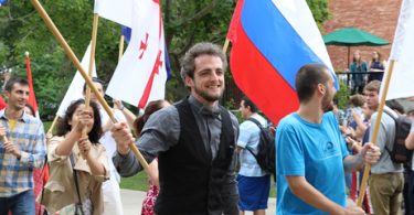 Beloit College students carry the international flags of their home countries.