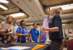 A college counselor speaks with students at a CTCL college fair.