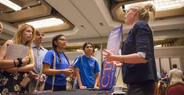 A college counselor speaks with students at a CTCL college fair.
