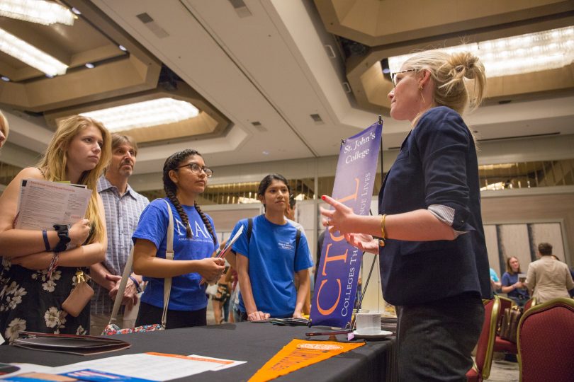 A college counselor speaks with students at a CTCL college fair.