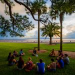 First-year students gather in a circle on the New College Bayfront during orientation.