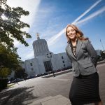 Willamette student stands outside the Oregon State Capitol