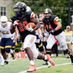 A Kalamazoo College running back runs during a football game