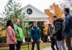 Six students gather near the Hicks Student Center at Kalamazoo College.