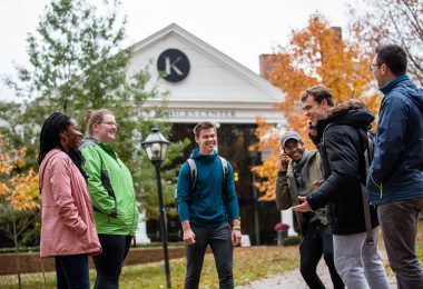 Six students gather near the Hicks Student Center at Kalamazoo College.
