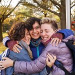 Students hugging one another