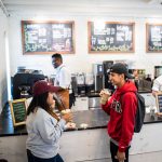 : Two Guilford College students enjoy iced drinks at Rachel’s Rose Cottage, the on-campus coffee shop.