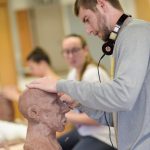Professor Kensuke Yamada teaches Ceramics 1 and 2 students as they work on various projects.
