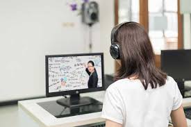 a student listens and watches an online course